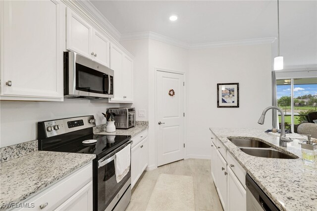 16126 Rosemallow Ln, Alva, FL 33920 - kitchen with stainless steel appliances, a sink, ornamental molding, white cabinets, and light stone countertops