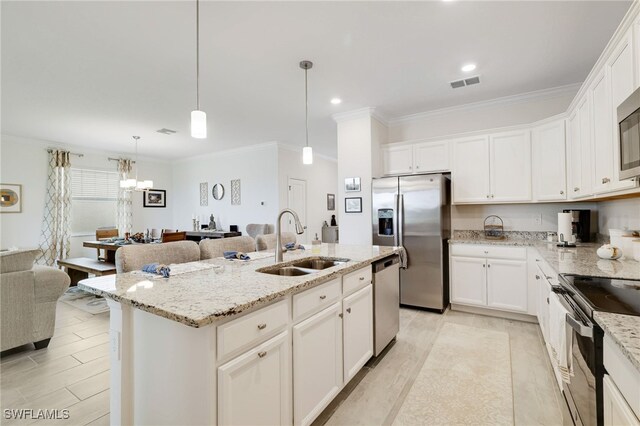 16126 Rosemallow Ln, Alva, FL 33920 - kitchen featuring stainless steel appliances, a sink, crown molding, open floor plan, and white cabinetry