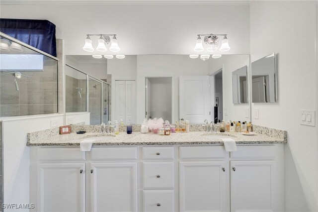 16126 Rosemallow Ln, Alva, FL 33920 - bathroom featuring a stall shower, double vanity, and a chandelier