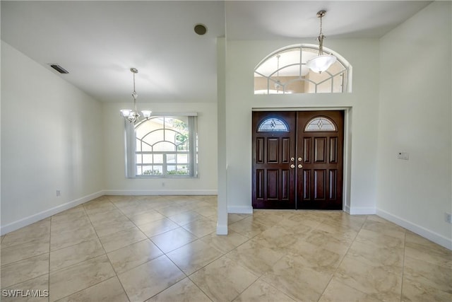 1101 SE 14th Ter, Cape Coral, FL 33990 - foyer featuring a chandelier and baseboards