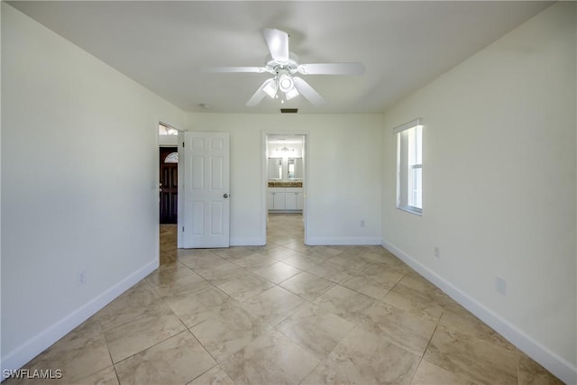 1101 SE 14th Ter, Cape Coral, FL 33990 - unfurnished bedroom with a ceiling fan and ensuite bath
