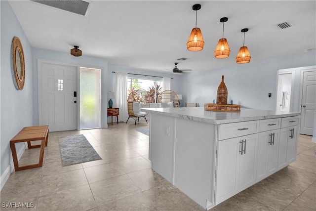 2317 El Dorado Pkwy W, Cape Coral, FL 33914 - kitchen featuring ceiling fan, white cabinetry, decorative light fixtures, light countertops, and a center island