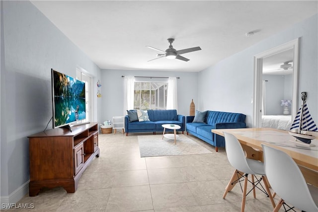 2317 El Dorado Pkwy W, Cape Coral, FL 33914 - living room featuring a ceiling fan, light tile patterned flooring, and baseboards