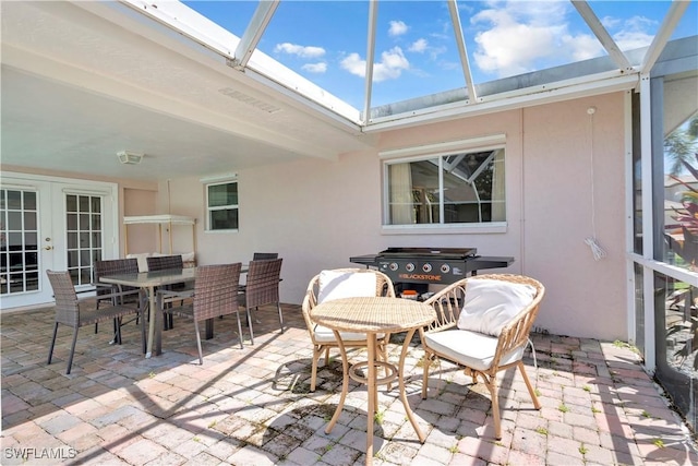 2317 El Dorado Pkwy W, Cape Coral, FL 33914 - sunroom with french doors and outdoor dining area