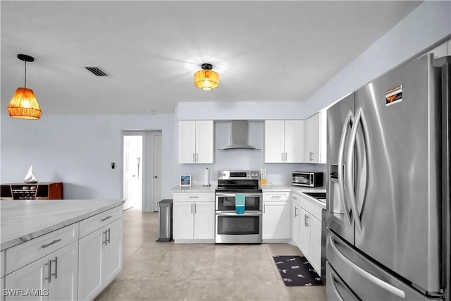 2317 El Dorado Pkwy W, Cape Coral, FL 33914 - kitchen featuring stainless steel appliances, wall chimney range hood, white cabinetry, and decorative light fixtures