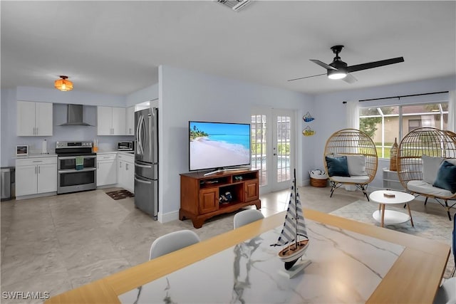 2317 El Dorado Pkwy W, Cape Coral, FL 33914 - living room featuring ceiling fan and baseboards