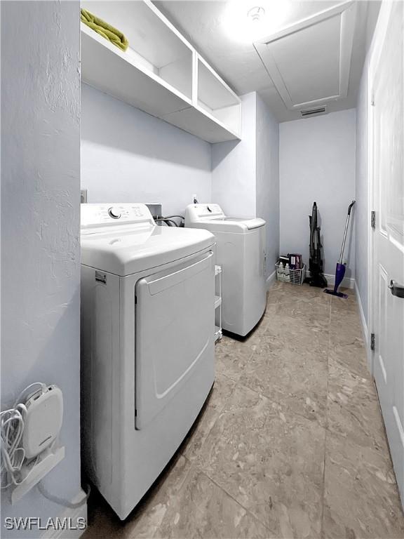 2317 El Dorado Pkwy W, Cape Coral, FL 33914 - laundry room with washing machine and dryer