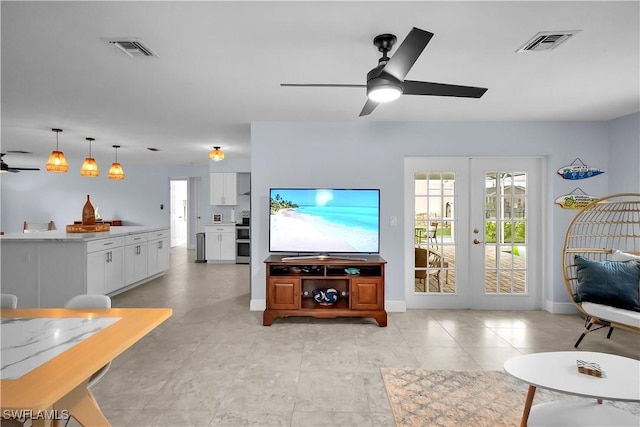 2317 El Dorado Pkwy W, Cape Coral, FL 33914 - living room featuring ceiling fan, french doors, and baseboards