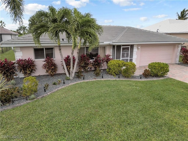 2317 El Dorado Pkwy W, Cape Coral, FL 33914 - ranch-style home featuring a garage, stucco siding, a front yard, and decorative driveway