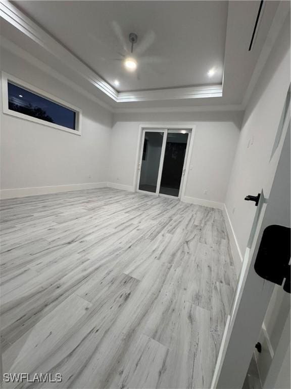 367 10th St NE, Naples, FL 34120 - unfurnished room with a raised ceiling, light wood finished floors, and crown molding