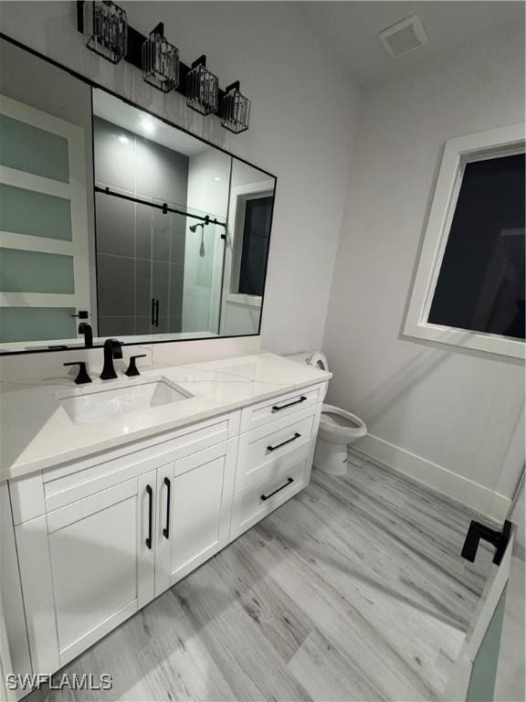 367 10th St NE, Naples, FL 34120 - full bath featuring vanity, a shower stall, and wood finished floors