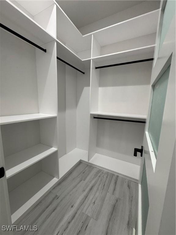 367 10th St NE, Naples, FL 34120 - spacious closet featuring wood finished floors