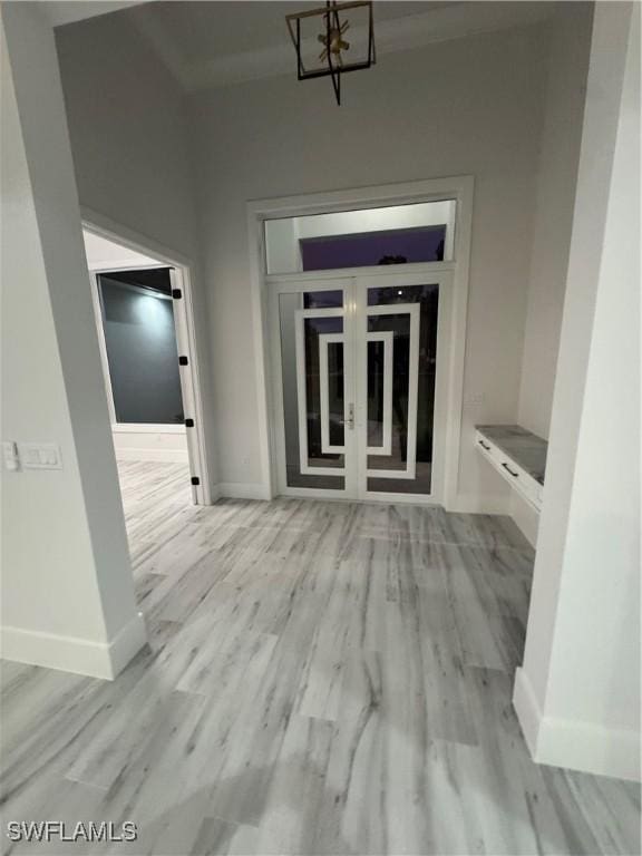 367 10th St NE, Naples, FL 34120 - hallway featuring baseboards and light wood finished floors