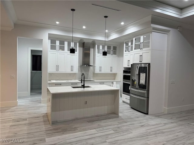 367 10th St NE, Naples, FL 34120 - kitchen featuring appliances with stainless steel finishes, wall chimney exhaust hood, light wood-style floors, light countertops, and crown molding