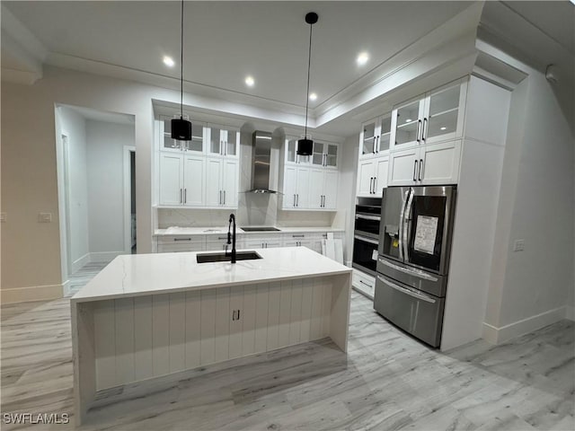 367 10th St NE, Naples, FL 34120 - kitchen featuring stainless steel appliances, wall chimney range hood, white cabinets, recessed lighting, and a kitchen island with sink