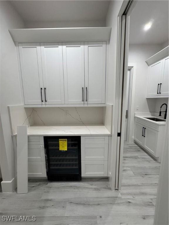 367 10th St NE, Naples, FL 34120 - detailed view of beverage cooler and wood finished floors