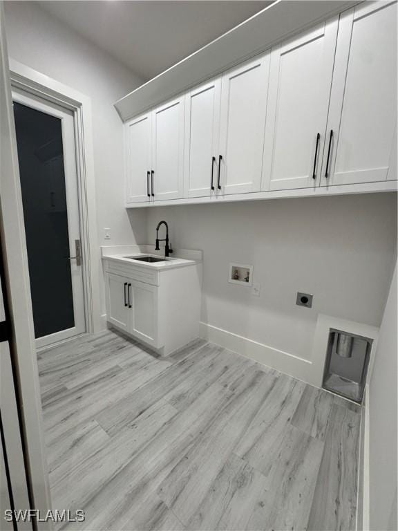 367 10th St NE, Naples, FL 34120 - laundry area featuring cabinet space, hookup for a washing machine, light wood finished floors, and hookup for an electric dryer