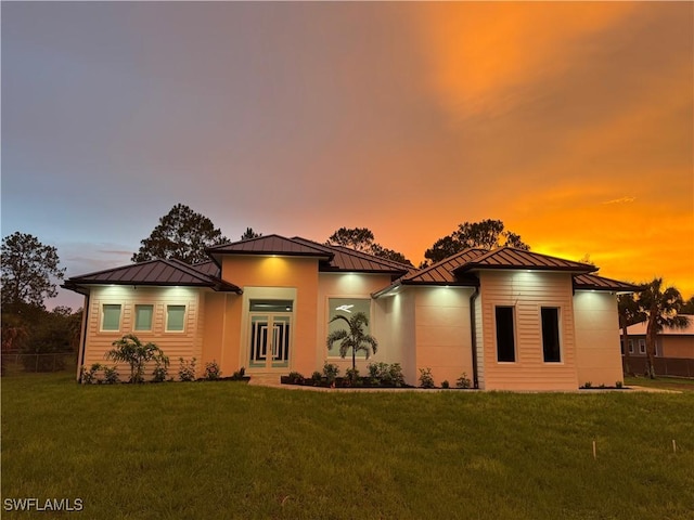 367 10th St NE, Naples, FL 34120 - prairie-style house featuring a standing seam roof, a yard, a metal roof, and french doors