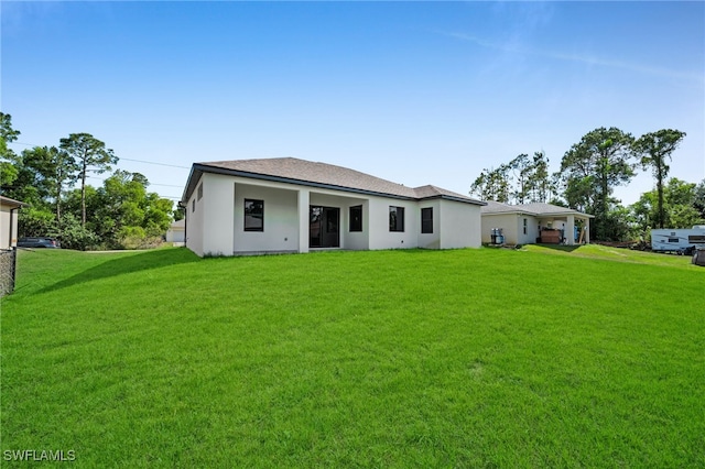 2512 10th St W, Lehigh Acres, FL 33971 - view of front of home with a front lawn and stucco siding