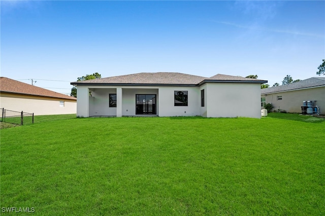 2512 10th St W, Lehigh Acres, FL 33971 - rear view of property featuring stucco siding