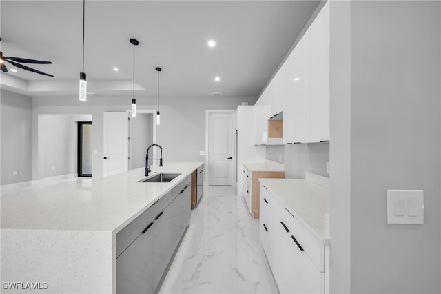 2512 10th St W, Lehigh Acres, FL 33971 - kitchen featuring modern cabinets, a sink, light marble finish flooring, white cabinetry, and recessed lighting