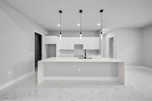2512 10th St W, Lehigh Acres, FL 33971 - kitchen with a sink, modern cabinets, white cabinets, baseboards, and light marble finish floors