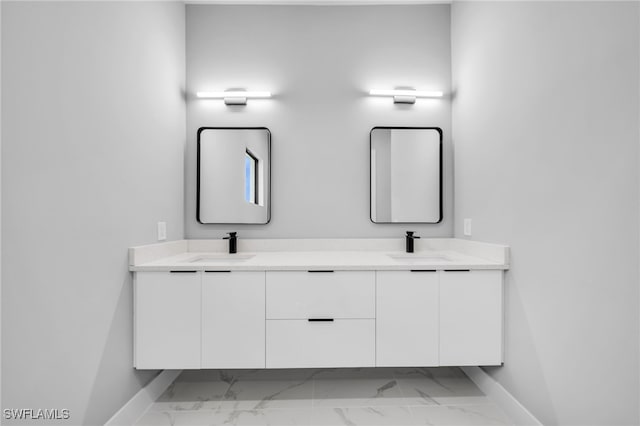 2512 10th St W, Lehigh Acres, FL 33971 - full bathroom featuring marble look tiles, baseboards, and double vanity