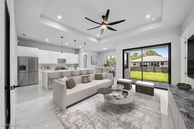 2512 10th St W, Lehigh Acres, FL 33971 - living area with a raised ceiling, recessed lighting, ceiling fan, and light marble finish flooring