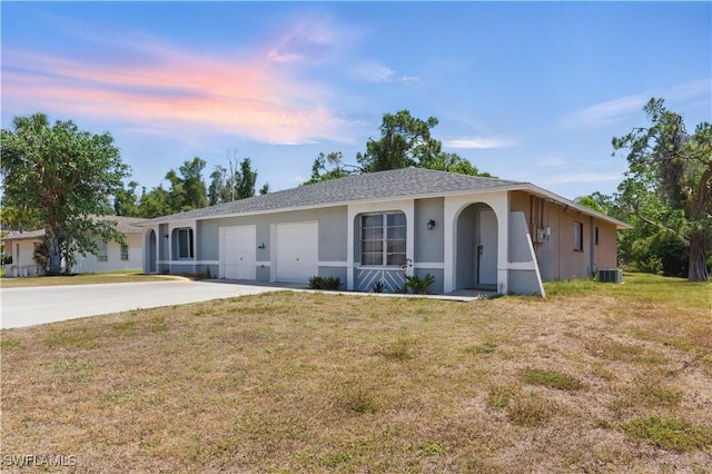 1423 SE 24th Ave, Cape Coral, FL 33990 - single story home with driveway, a front yard, stucco siding, a garage, and central AC
