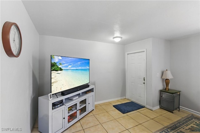 1423 SE 24th Ave, Cape Coral, FL 33990 - unfurnished living room featuring light tile patterned flooring and baseboards