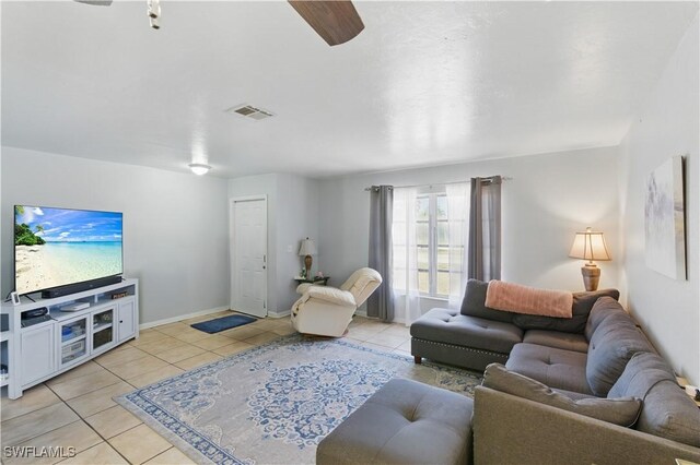 1423 SE 24th Ave, Cape Coral, FL 33990 - living room featuring light tile patterned flooring, a ceiling fan, and baseboards