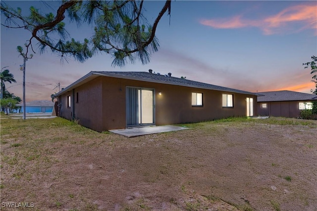 1423 SE 24th Ave, Cape Coral, FL 33990 - back of property at dusk with stucco siding
