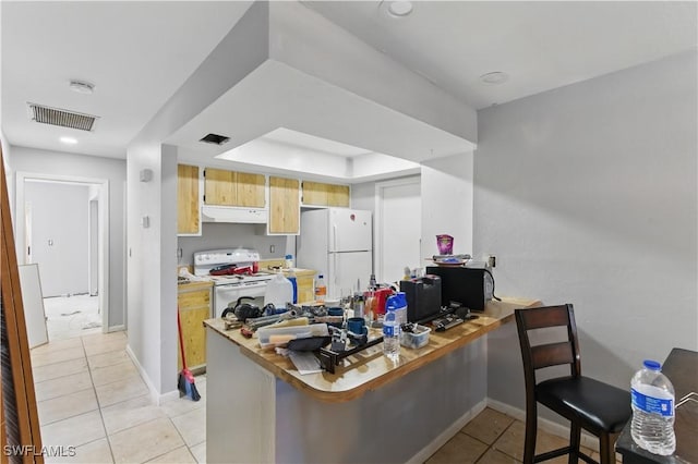 1423 SE 24th Ave, Cape Coral, FL 33990 - kitchen with white appliances, under cabinet range hood, light tile patterned floors, a peninsula, and baseboards