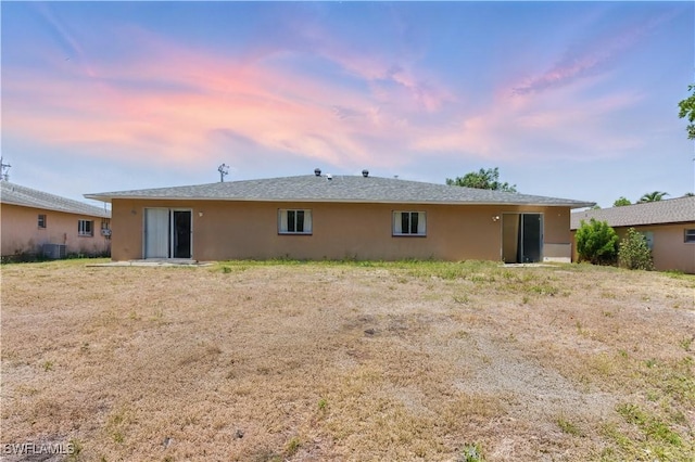 1423 SE 24th Ave, Cape Coral, FL 33990 - back of property with stucco siding and central AC