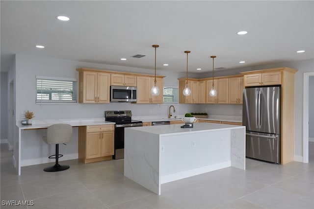 3866 Villmoor Ln, Fort Myers, FL 33919 - kitchen featuring appliances with stainless steel finishes, light brown cabinetry, a kitchen island, and recessed lighting