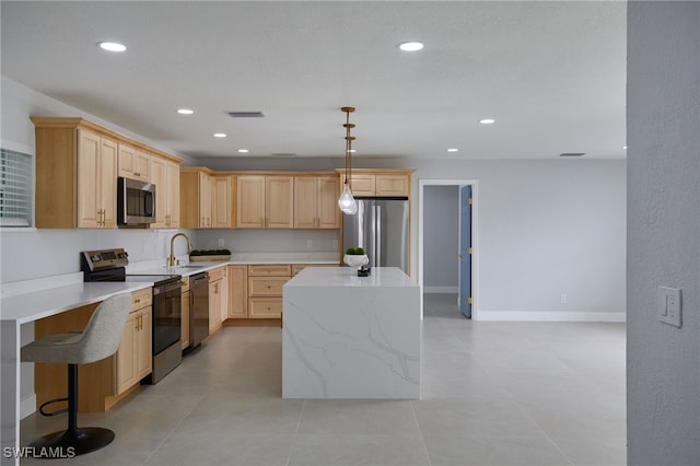 3866 Villmoor Ln, Fort Myers, FL 33919 - kitchen with stainless steel appliances, light brown cabinets, a sink, a kitchen island, and recessed lighting