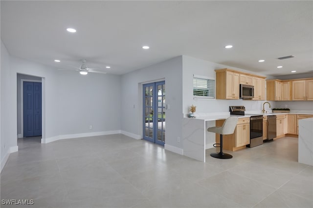 3866 Villmoor Ln, Fort Myers, FL 33919 - kitchen featuring appliances with stainless steel finishes, light brown cabinets, light countertops, recessed lighting, and baseboards