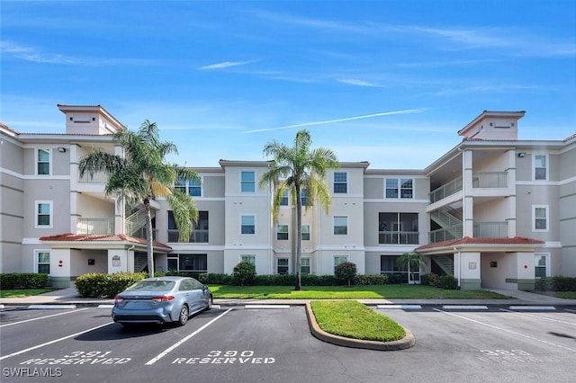 23520 Walden Center Dr Unit 207, Estero, FL 34134 - view of building exterior featuring uncovered parking