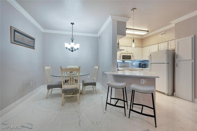 23520 Walden Center Dr Unit 207, Estero, FL 34134 - kitchen with white appliances, ornamental molding, a chandelier, decorative light fixtures, and a breakfast bar