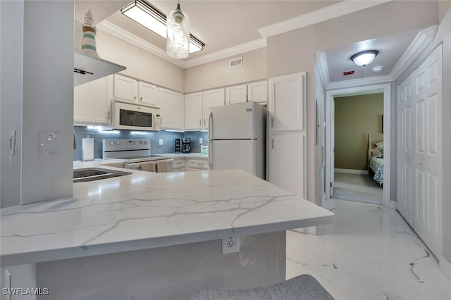 23520 Walden Center Dr Unit 207, Estero, FL 34134 - kitchen featuring white appliances, ornamental molding, a peninsula, white cabinets, and light stone countertops