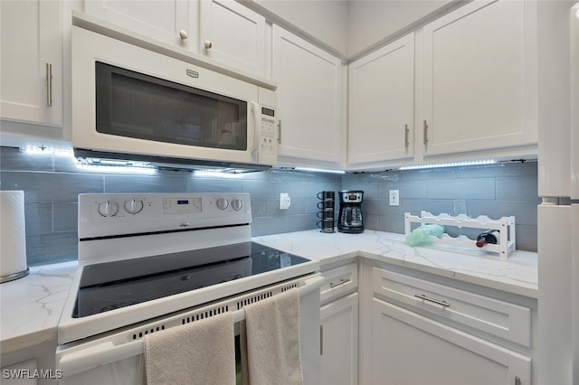 23520 Walden Center Dr Unit 207, Estero, FL 34134 - kitchen featuring white appliances, backsplash, white cabinets, and light stone countertops