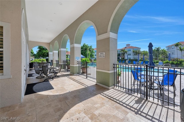 23520 Walden Center Dr Unit 207, Estero, FL 34134 - view of patio / terrace with a community pool