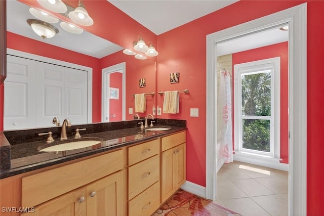 1043 Sand Castle Rd, Sanibel, FL 33957 - full bathroom with double vanity, tile patterned floors, and a shower with shower curtain