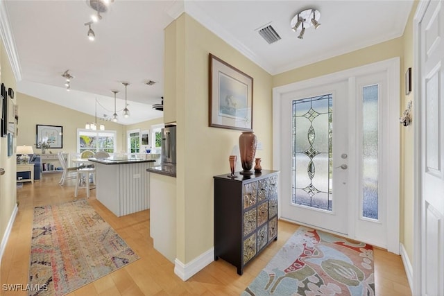 1043 Sand Castle Rd, Sanibel, FL 33957 - foyer with light wood finished floors, crown molding, and lofted ceiling