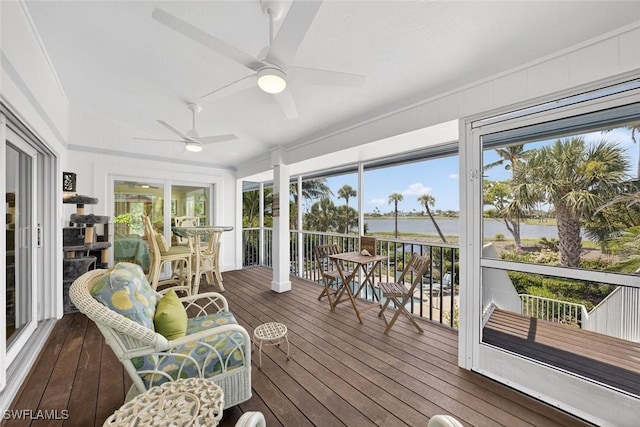 1043 Sand Castle Rd, Sanibel, FL 33957 - sunroom / solarium featuring a water view, ceiling fan, and wood-type flooring