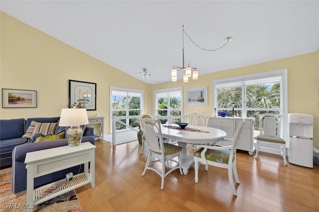 1043 Sand Castle Rd, Sanibel, FL 33957 - dining space with a chandelier, healthy amount of natural light, light wood finished floors, and vaulted ceiling