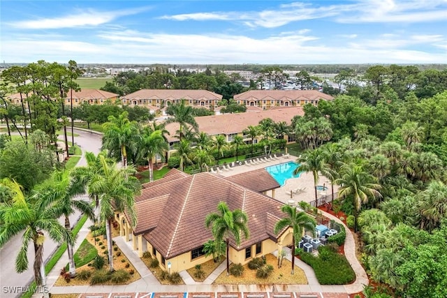 1089 Winding Pines Cir Unit 106, Cape Coral, FL 33909 - aerial perspective of suburban area featuring a pool and a tree filled landscape