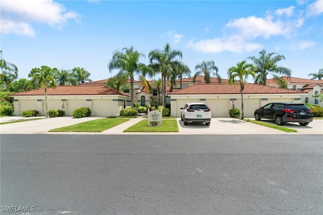 10921 Santa Margherita Rd Unit 104, Estero, FL 34135 - view of front of home with a tile roof and stucco siding