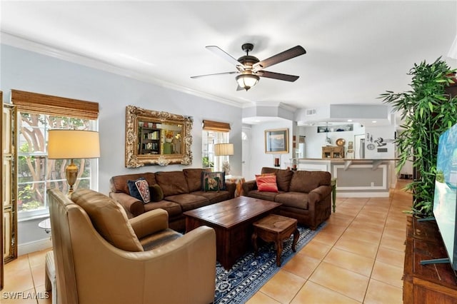 10921 Santa Margherita Rd Unit 104, Estero, FL 34135 - living room featuring light tile patterned floors, a ceiling fan, plenty of natural light, and ornamental molding