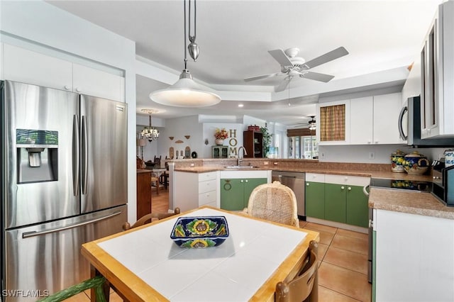 10921 Santa Margherita Rd Unit 104, Estero, FL 34135 - kitchen featuring appliances with stainless steel finishes, a peninsula, a ceiling fan, and white cabinets